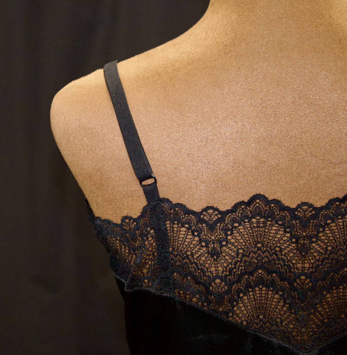Black lace lingerie on a mannequin against a dark background back
