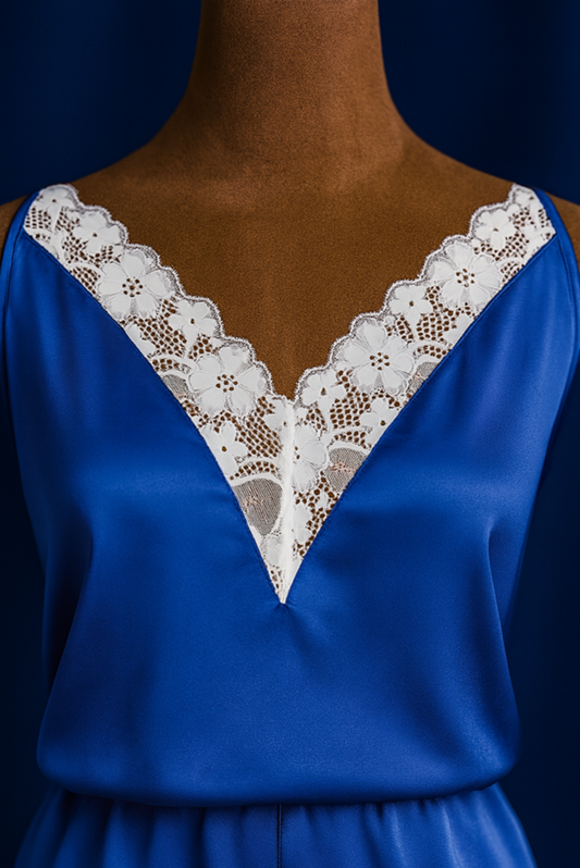 Blue satin set with lace detailing on a mannequin against a dark background