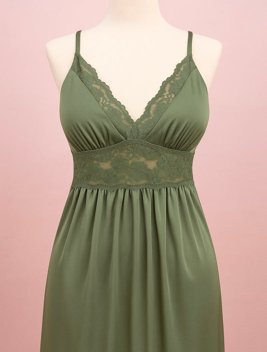 Green nightgown with lace details on a mannequin against a pink background