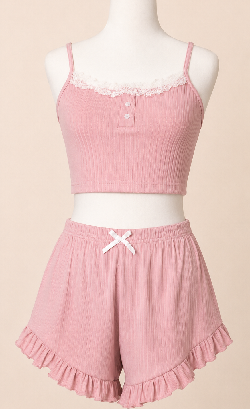 Pink pajama set on a mannequin against a beige background
