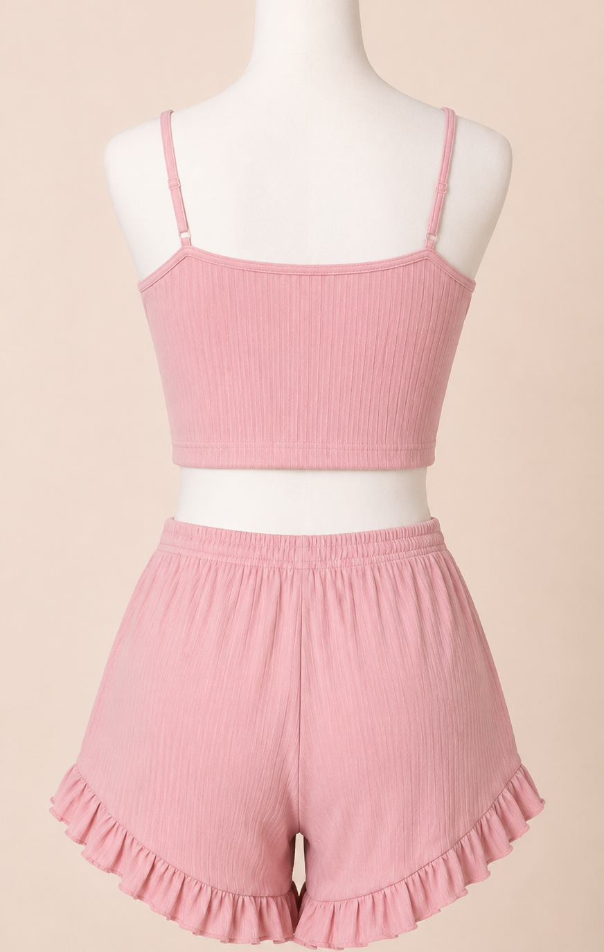 Pink ribbed tank top and shorts set on a mannequin against a beige background