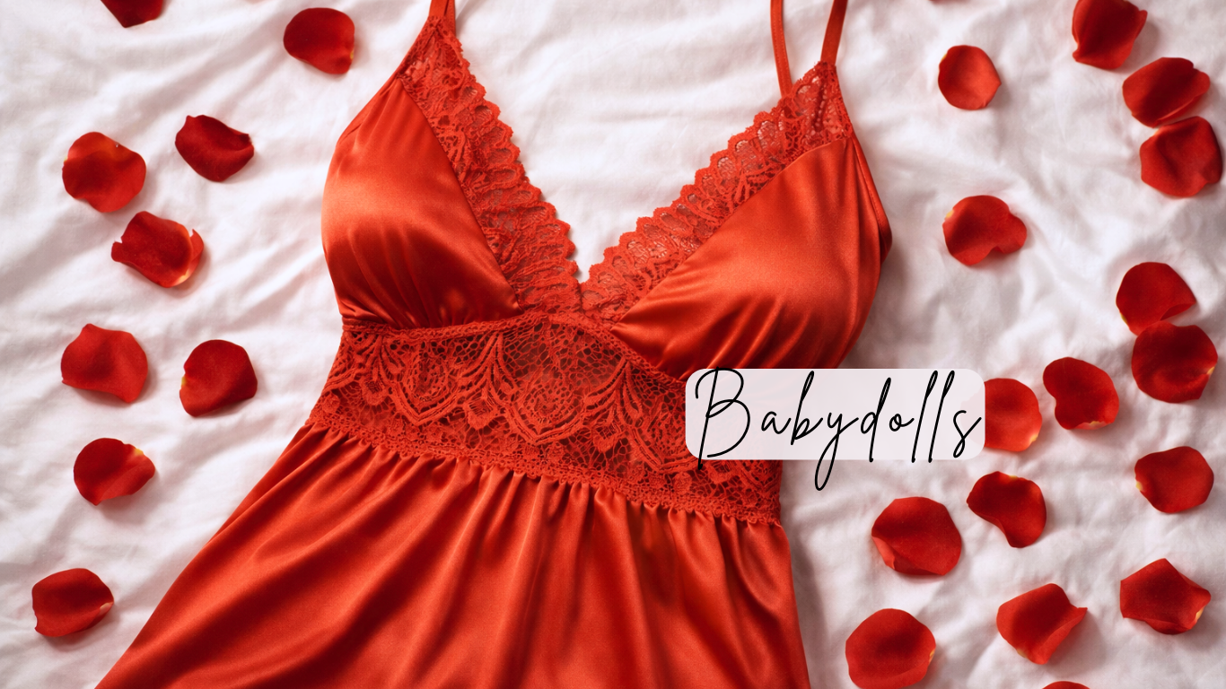 Red lace babydoll dress on a white surface with red rose petals