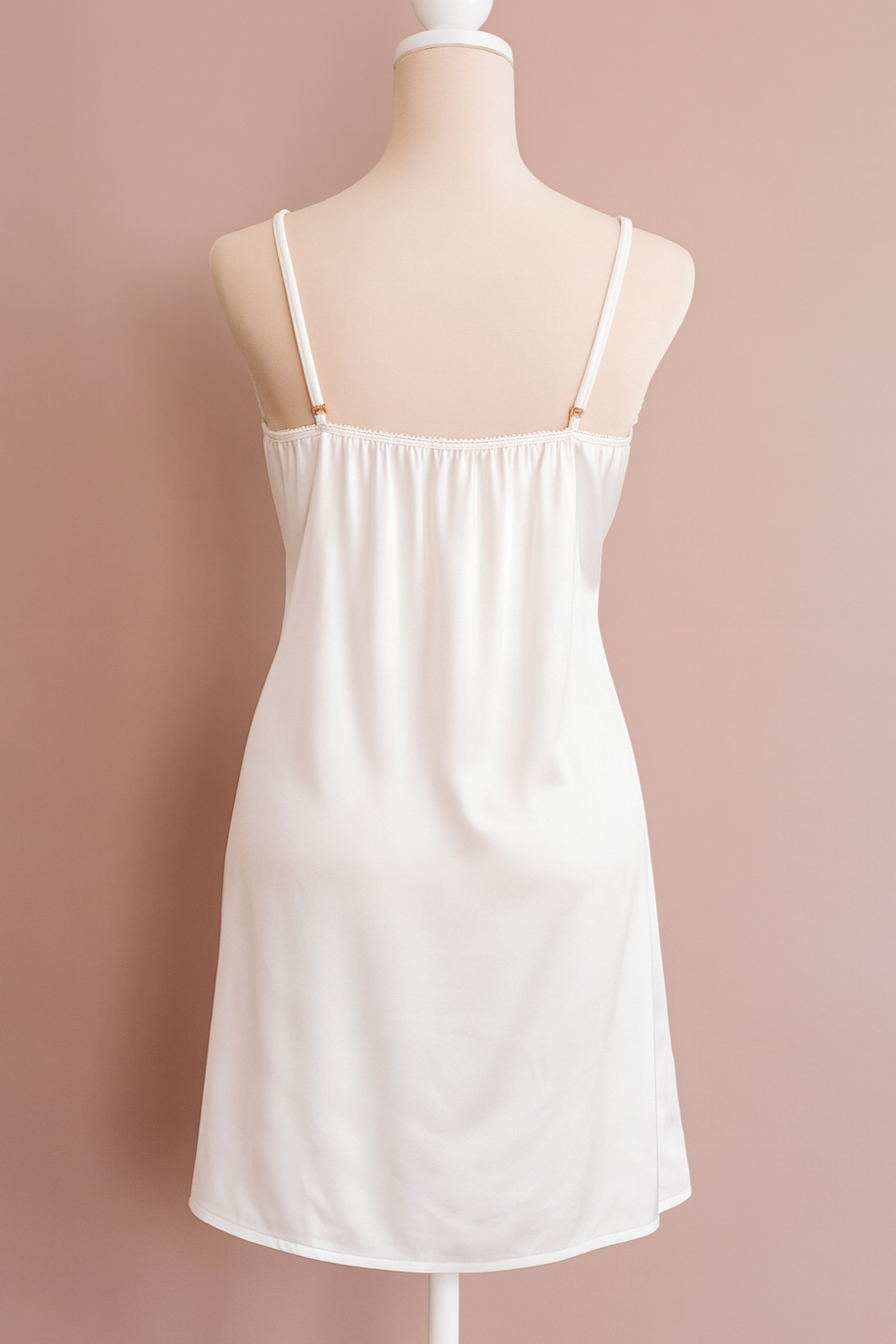 White back chemise on a mannequin against a pink background