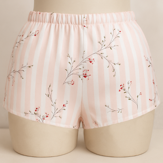 Floral-patterned shorts on a mannequin against a neutral background